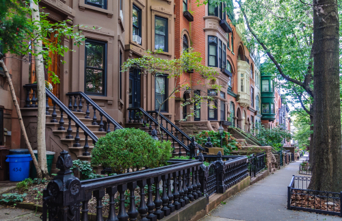 NYC landmark properties in the Park Slope Historic District featuring historic brownstones along a tree lined street