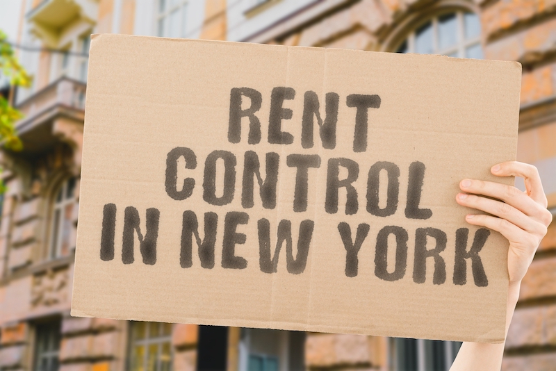 NYC rent stabilization laws illustrated by a rent control sign outside a New York City apartment building