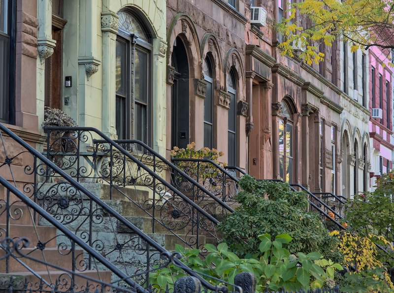 Seasonality in NYC real estate—spring blossoms and fall leaves on Manhattan streets.