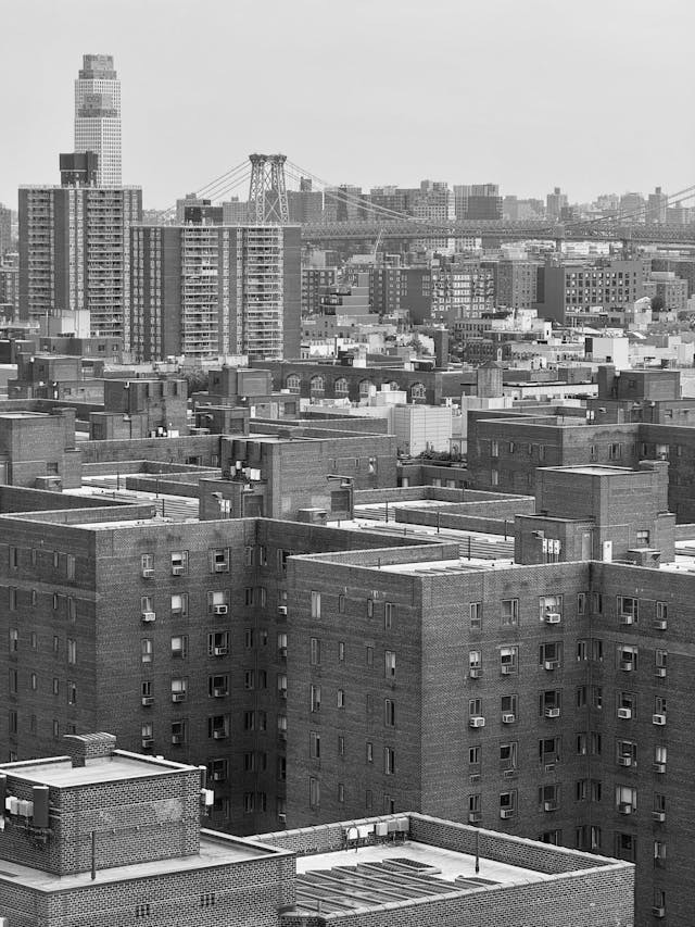 Street of New York City apartment buildings representing market-rate rentals affected by Good Cause Eviction law.
