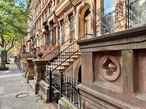 South Harlem brownstone row with stoops and ornate stone details in Mount Morris Park Historic District